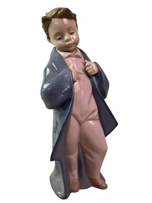 Lot 120 - NAO FIGURES OF A BOY AND GIRL IN 'DADDY'S COAT'