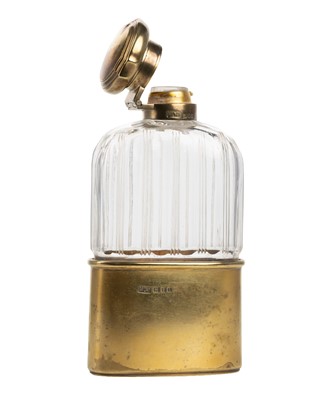 Lot 1141 - GEORGE V SILVER-GILT AND GLASS HIP FLASK