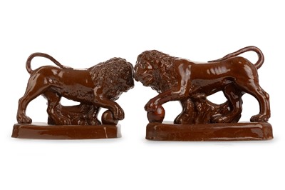 Lot 1407 - LATE GEORGIAN PAIR OF STONEWARE LIONS