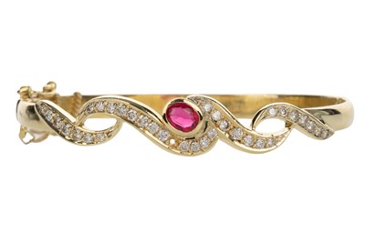 Lot 658 - GOLD RUBY SET BANGLE