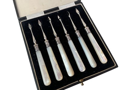 Lot 137 - SET OF SIX GEORGE V SILVER AND MOTHER OF PEARL HANDLED NUT PICKS