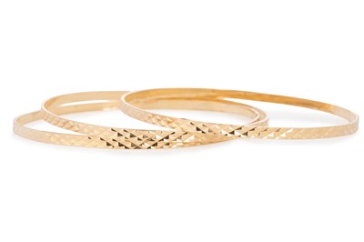 Lot 424 - THREE GOLD BANGLES