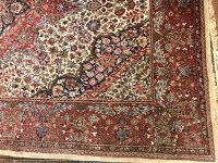 Lot 673 - KASHAN BORDERED RUG decorated with large...