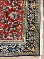 Lot 695 - KIRMAN BORDERED RUG decorated with central...