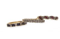 Lot 126 - NINE CARAT GOLD DIAMOND AND RUBY RING of wave...