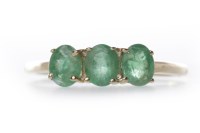 Lot 87 - EMERALD THREE STONE RING the oval emeralds of...