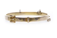 Lot 62 - TEN CARAT GOLD BUCKLE MOTIF BANGLE with safety...
