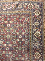 Lot 573 - KASHAN BORDERED RUG decorated with allover...