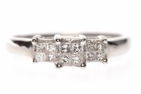 Lot 182 - DIAMOND DRESS RING the tiered bezel set with...