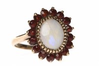 Lot 210 - OPAL AND GARNET CLUSTER RING the central oval...