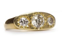 Lot 381 - DIAMOND THREE STONE RING with a central star...