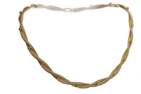 Lot 499 - GOLD PLATED NECKLET formed by woven and...