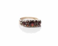 Lot 1838 - GARNET RING set with round garnets, in a...