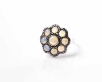 Lot 1843 - OPAL CLUSTER RING the central round cabochon...
