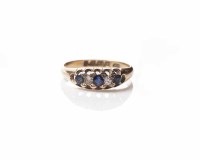 Lot 1847 - SAPPHIRE AND DIAMOND RING set with a central...
