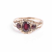 Lot 1859 - VICTORIAN GARNET THREE STONE RING with a...