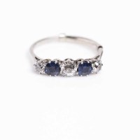 Lot 1864 - SAPPHIRE AND DIAMOND FIVE STONE RING the two...