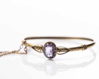 Lot 1896 - VICTORIAN AMETHYST BANGLE the central oval...