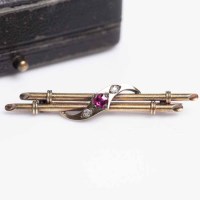 Lot 1935 - CREATED RUBY AND DIAMOND BAR BROOCH set with a...