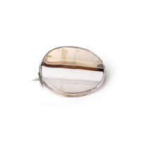 Lot 1956 - SCOTTISH AGATE BROOCH of oval form, set with a...