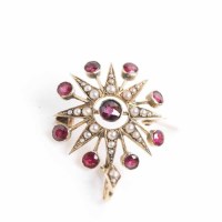 Lot 1963 - RUBY AND PEARL HOLBEIN of star form, set with...
