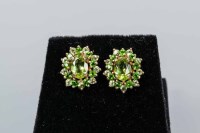 Lot 1695 - PAIR OF PERIDOT CLUSTER EARRINGS the central...