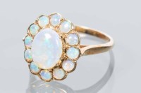Lot 1715 - OPAL CLUSTER RING the central oval cabochon...