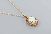 Lot 1717 - LARGE OPAL PENDANT with an oval cabochon cut...