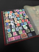 Lot 339 - RED STOCK ALBUM OF STAMPS with postmarks from...