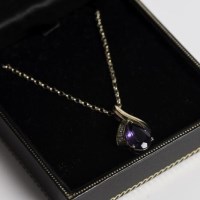 Lot 1732 - GOLD AMETHYST AND DIAMOND PENDANT set with a...
