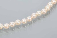 Lot 1733 - CULTURED PEARL NECKLACE with a diamond set...