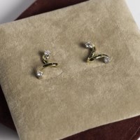 Lot 1747 - DIAMOND TWIST EARRINGS each set with two...