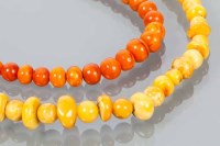 Lot 1756 - TWO AMBER BEAD NECKLACES one in yellow tones,...