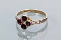 Lot 1765 - GARNET RING set with four round garnets,...