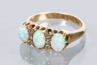Lot 1777 - OPAL AND DIAMOND RING with three oval opals...