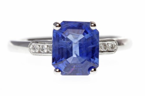 Lot 33 - SAPPHIRE AND DIAMOND RING set with a central...