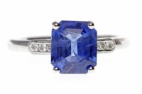 Lot 33 - SAPPHIRE AND DIAMOND RING set with a central...