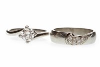 Lot 50 - PLATINUM DIAMOND SOLITAIRE RING with a four...