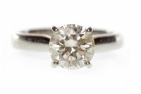 Lot 66 - PLATINUM DIAMOND SOLITAIRE RING with a four...