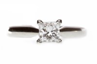 Lot 143 - PLATINUM DIAMOND SOLITAIRE RING with a four...