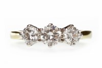 Lot 373 - DIAMOND THREE STONE RING set with a central...