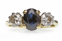 Lot 382 - SAPPHIRE AND DIAMOND THREE STONE RING with a...