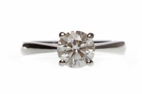 Lot 463 - PLATINUM DIAMOND SOLITAIRE RING with a four...