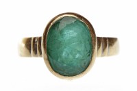 Lot 488 - EMERALD DRESS RING set with a single large...