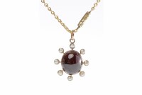 Lot 504 - GARNET AND PEARL PENDANT set with a central...