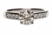 Lot 550 - PLATINUM DIAMOND SOLITAIRE RING with a four...