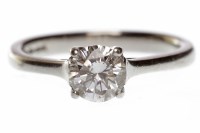 Lot 592 - PLATINUM DIAMOND SOLITAIRE RING with a four...