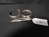 Lot 107 - TWO SILVER BANGLES and a silver lozenge shaped...