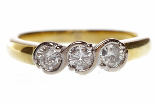 Lot 625 - EIGHTEEN CARAT GOLD DIAMOND THREE STONE RING...