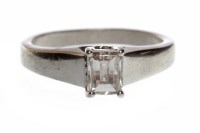 Lot 705 - PLATINUM DIAMOND SOLITAIRE RING with a four...